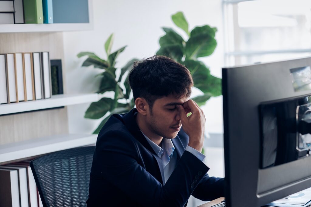 businessman get stress while working at office,headache