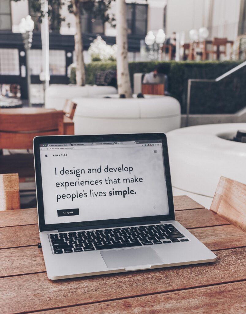 Picture of a laptop that says "I design and develop experiences that make people's lives simple"